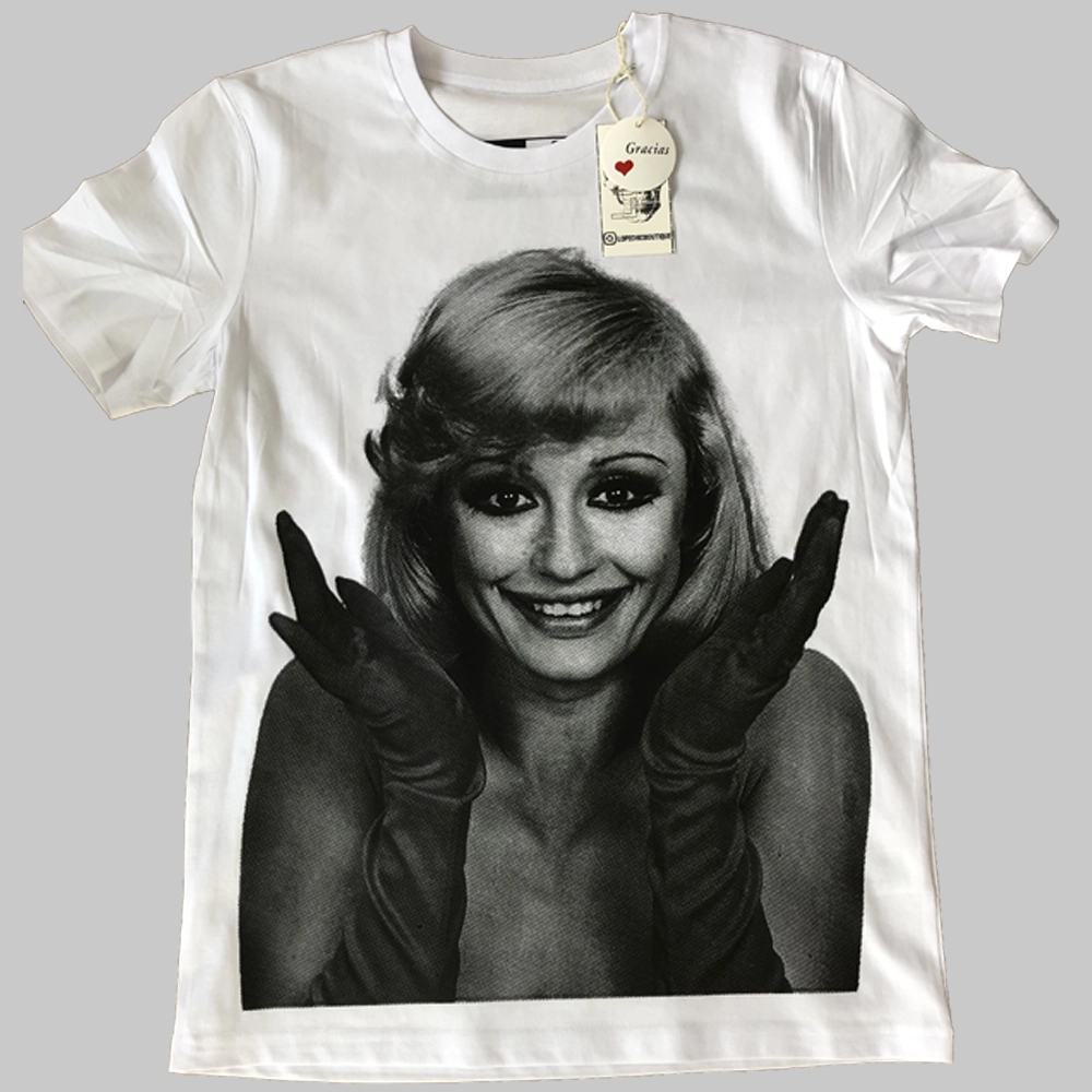 Camiseta blanca de algodón orgánico con imagen frontal de Raffaella Carrà en blanco y negro y diseño trasero con su nombre en letras grandes y detalle de calavera.